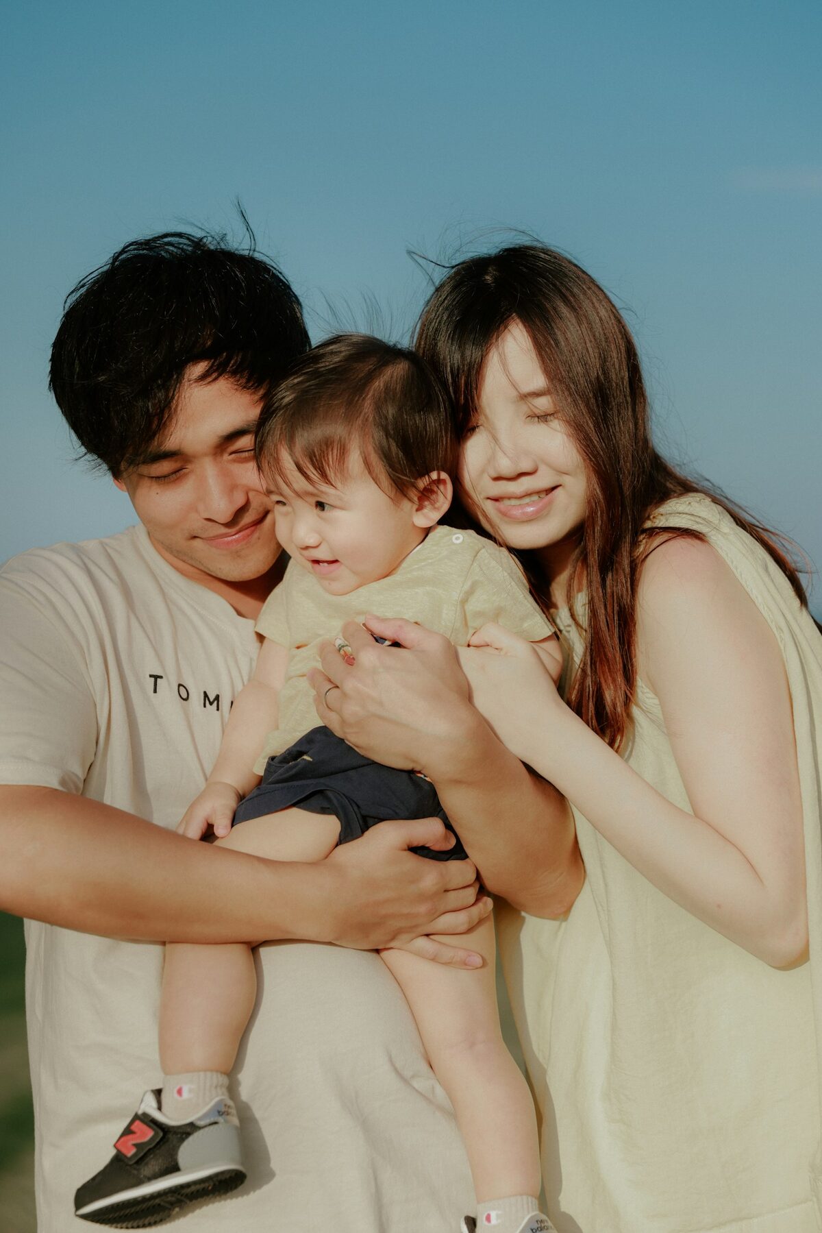 Happy parents holding their baby outdoors